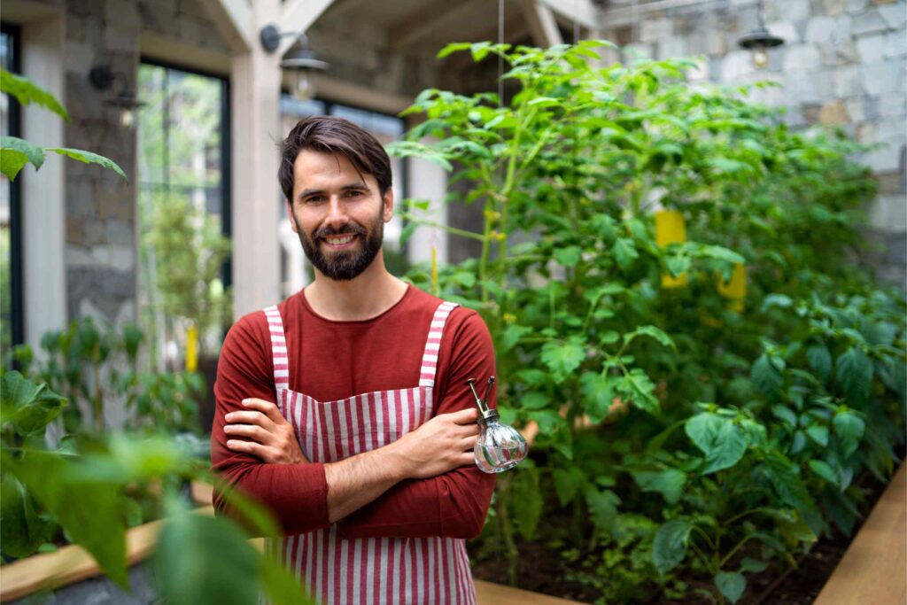 portrait-of-man-gardener-standing-in-greenhouse-l-2024-10-18-14-38-01-utc
